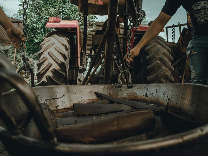 Agricultural mechanic maintaining working farm equipment